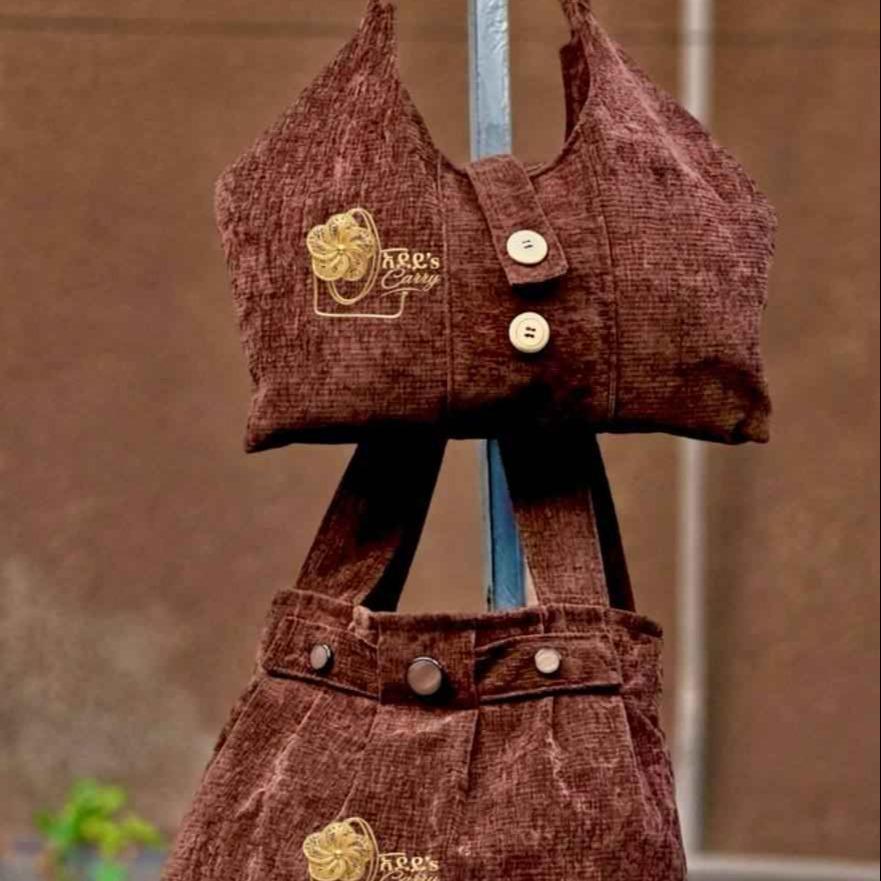 Adeys carry bag showcasing signature stitching, logo, and textured fabric with a spacious interior